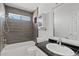 Updated bathroom featuring wood-look tile, white fixtures, and modern finishes at 1160 E Hampton Cir, Mesa, AZ 85204