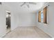 Bedroom features tile floors, ceiling fan, and en suite bathroom at 1160 E Hampton Cir, Mesa, AZ 85204
