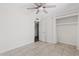 Bright bedroom with neutral tile flooring, ceiling fan, and closet at 1160 E Hampton Cir, Mesa, AZ 85204