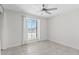 Light and airy bedroom with a large window and neutral tile flooring at 1160 E Hampton Cir, Mesa, AZ 85204