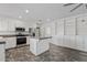 Open kitchen with stainless steel appliances, granite island and custom shelving at 1160 E Hampton Cir, Mesa, AZ 85204