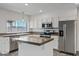 Updated kitchen featuring white cabinets, modern appliances, granite countertops, and a kitchen island at 1160 E Hampton Cir, Mesa, AZ 85204