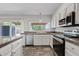 Bright kitchen featuring white cabinets, stainless appliances and granite countertops at 1160 E Hampton Cir, Mesa, AZ 85204