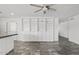 Open living room area featuring custom shelving and ceiling fan at 1160 E Hampton Cir, Mesa, AZ 85204