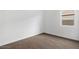 Simple bedroom with brown carpeting, white walls, and a window letting in natural light at 1373 S Vista Ave, Florence, AZ 85132
