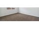 Basic bedroom with plush brown carpet, white walls, base trim, and a window at 1373 S Vista Ave, Florence, AZ 85132