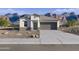 Charming single-story home with neutral tones, desert landscaping, and an attached two-car garage at 1373 S Vista Ave, Florence, AZ 85132