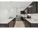 Modern kitchen with dark cabinetry, stainless steel appliances, and a marble-look countertop island at 1373 S Vista Ave, Florence, AZ 85132