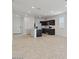 Open-concept living space with tile flooring adjoining the kitchen and leading to the front entrance at 1373 S Vista Ave, Florence, AZ 85132