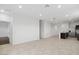 Spacious living area with tile flooring, bright white walls, and an open layout leading to the kitchen at 1373 S Vista Ave, Florence, AZ 85132