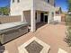 Private backyard with a stone patio, a cozy fire pit, and a relaxing hot tub at 1400 S Crossbow Ct, Chandler, AZ 85286