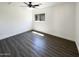 Bedroom featuring gray wood-look floors and bright window offering great natural light at 1400 S Crossbow Ct, Chandler, AZ 85286