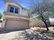 Two-story home with a neutral color scheme, a two-car garage and a well-maintained front yard at 1400 S Crossbow Ct, Chandler, AZ 85286