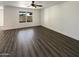 A spacious living room features wood-look flooring and a window overlooking the back yard at 1400 S Crossbow Ct, Chandler, AZ 85286