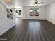 Spacious open-concept living room with wood-look floors and staircase at 1400 S Crossbow Ct, Chandler, AZ 85286