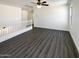 Bright loft area with neutral walls, white banister, and attractive gray wood-look floors at 1400 S Crossbow Ct, Chandler, AZ 85286