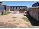 Unkempt backyard featuring dirt and overgrown grass, with a metal shed in view at 1602 N 57Th Ave, Phoenix, AZ 85035
