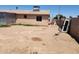 Spacious backyard featuring a metal shed, dirt and overgrown grass and exterior windows at 1602 N 57Th Ave, Phoenix, AZ 85035