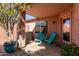 Relaxing covered back patio with chairs and a lush potted tree at 16818 S 23Rd St, Phoenix, AZ 85048