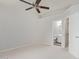 Bright bedroom featuring neutral walls, carpet, a ceiling fan, and ensuite bathroom at 16818 S 23Rd St, Phoenix, AZ 85048