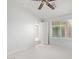 Bright bedroom featuring neutral walls, carpet, a ceiling fan, and window views at 16818 S 23Rd St, Phoenix, AZ 85048