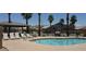 Beautiful community pool featuring lounge chairs, a gazebo and lush palm trees in a desert landscape at 16818 S 23Rd St, Phoenix, AZ 85048