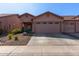 Charming home featuring a two-car garage and well-manicured desert landscaping in front at 16818 S 23Rd St, Phoenix, AZ 85048