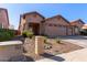 Charming home featuring a two-car garage and well-manicured desert landscaping in front at 16818 S 23Rd St, Phoenix, AZ 85048