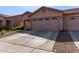 Charming home featuring a two-car garage and well-manicured desert landscaping in front at 16818 S 23Rd St, Phoenix, AZ 85048