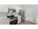 Efficient kitchen with white cabinets and stainless steel appliances at 16818 S 23Rd St, Phoenix, AZ 85048