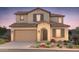 Charming two-story home featuring a tile roof, an attached garage, and desert landscaping at 18156 E Tiffany Dr, Queen Creek, AZ 85142
