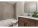 Modern bathroom featuring a wood vanity, mirror, and tiled shower-over-tub at 18610 N 45Th Ave, Glendale, AZ 85308