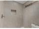 Tiled walk-in shower with shower niche and accessible showerhead at 18610 N 45Th Ave, Glendale, AZ 85308