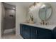 Modern bathroom featuring double sinks, custom cabinets, and a tiled walk-in shower at 18610 N 45Th Ave, Glendale, AZ 85308