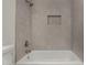 Modern bathroom showcasing a shower-over-tub with neutral tile and convenient built-in niche at 18610 N 45Th Ave, Glendale, AZ 85308
