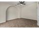 A bright bedroom featuring a ceiling fan and an unique decorative arch at 18610 N 45Th Ave, Glendale, AZ 85308