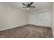 Spacious bedroom with carpet, ceiling fan, and double-door closets for plenty of storage at 18610 N 45Th Ave, Glendale, AZ 85308
