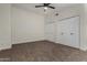 Spacious bedroom with carpet, ceiling fan, and double-door closets for plenty of storage at 18610 N 45Th Ave, Glendale, AZ 85308