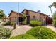 Attractive exterior of home, featuring desert landscaping, a brick walkway, and mature shrubs at 18610 N 45Th Ave, Glendale, AZ 85308