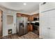 Eat-in kitchen featuring stainless steel appliances, tile floors, and an exterior door at 18610 N 45Th Ave, Glendale, AZ 85308