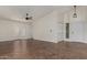 Spacious living room featuring vaulted ceilings, a ceiling fan, and sliding glass doors at 18610 N 45Th Ave, Glendale, AZ 85308
