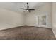 Primary bedroom with ceiling fan, neutral carpet, and French doors leading to the patio at 18610 N 45Th Ave, Glendale, AZ 85308