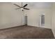 Spacious main bedroom with ceiling fan, neutral carpet, and ensuite bathroom at 18610 N 45Th Ave, Glendale, AZ 85308