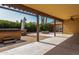 Beautiful covered patio with a hot tub, fire pit, and lush landscaping, ideal for outdoor relaxation at 18610 N 45Th Ave, Glendale, AZ 85308