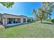 Beautiful backyard with a lush green lawn, patio, and mature trees at 19120 N 98Th Ln, Peoria, AZ 85382