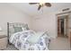 Comfortable bedroom features a ceiling fan, closet, and decorative bedding at 19120 N 98Th Ln, Peoria, AZ 85382
