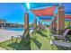 Relaxing poolside lounge area with shaded seating and a beautiful pool view at 19120 N 98Th Ln, Peoria, AZ 85382