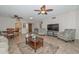 Spacious living room boasts tile flooring, ceiling fans and comfortable seating at 19120 N 98Th Ln, Peoria, AZ 85382