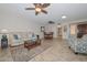 Bright living room with tile floors, ceiling fans, and comfortable seating, creating a welcoming atmosphere at 19120 N 98Th Ln, Peoria, AZ 85382