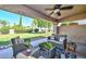 Relaxing covered patio featuring comfortable seating and views of the landscaped yard at 19120 N 98Th Ln, Peoria, AZ 85382